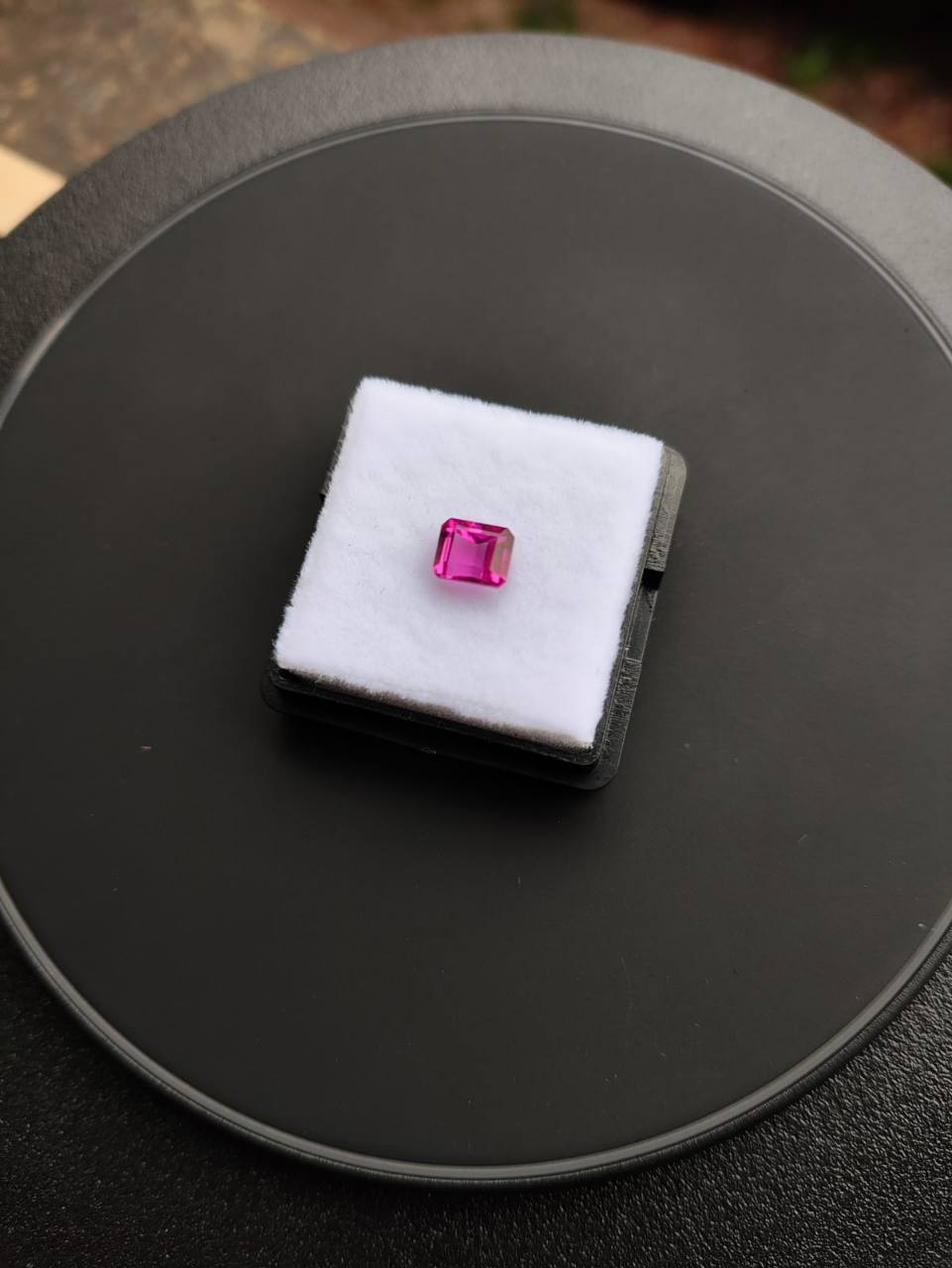 Natural Brazilian pink tourmaline on a white gemstone display
